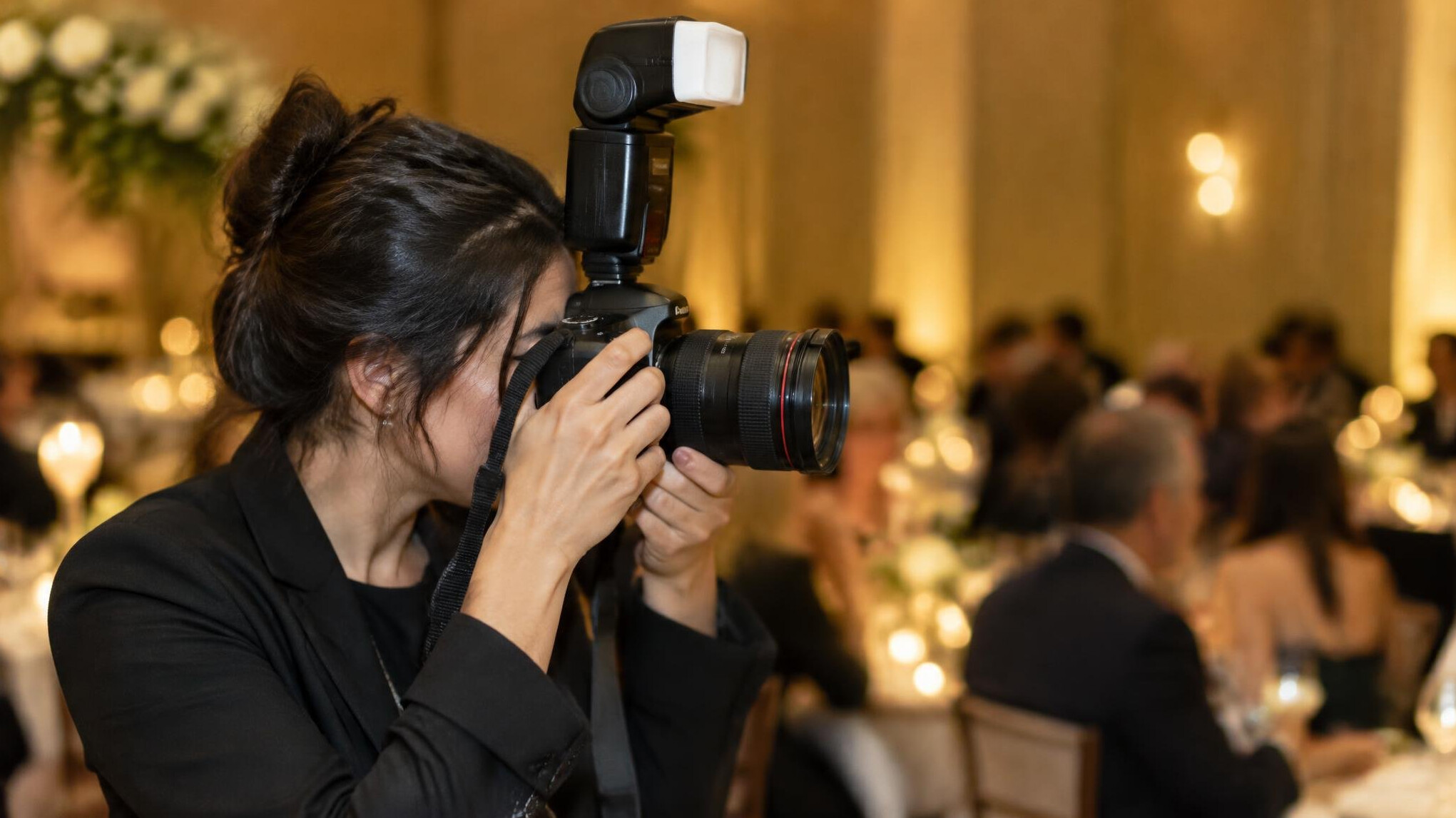 Photographer shooting with a camera and external flash